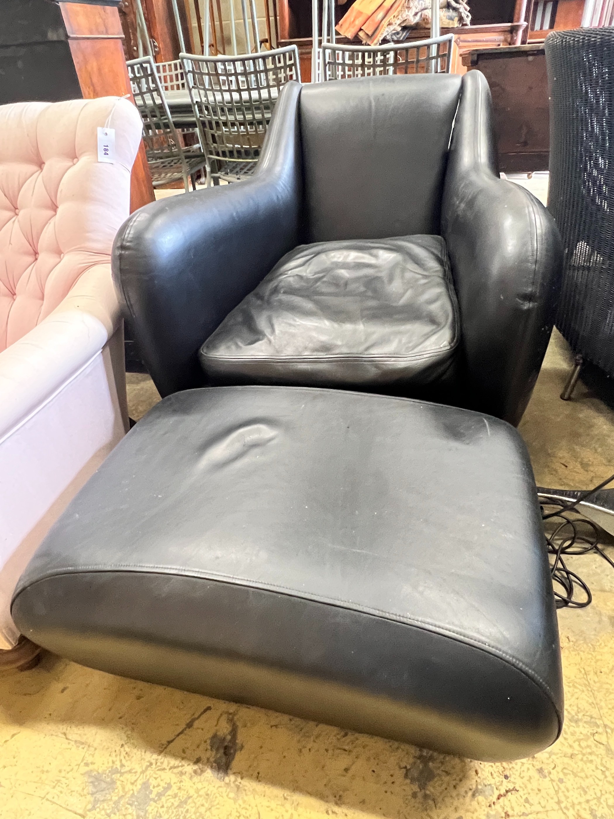 A Matthew Hilton black leather Balzac armchair, width 82cm, depth 100cm, height 82cm and a footstool